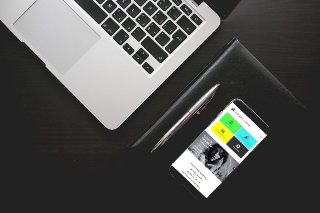 rci website displaying on a mobile phone placed next to a laptop against a dark background